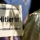 An anti-fascism sign reads: Breaking news—Hitler is dead!”